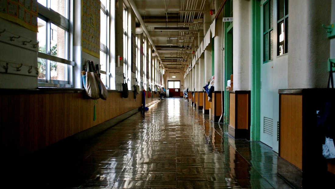 Long, sunlit school hallway