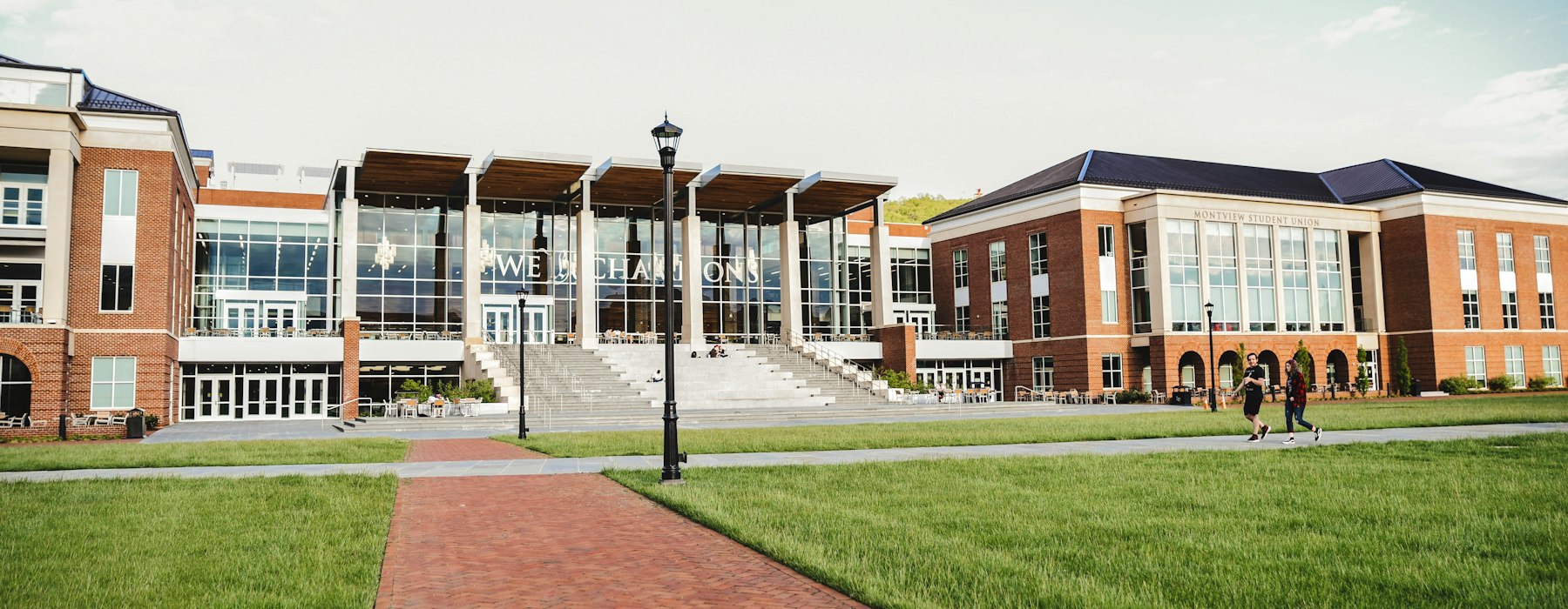 Brick school campus with a long walkway on a clear day