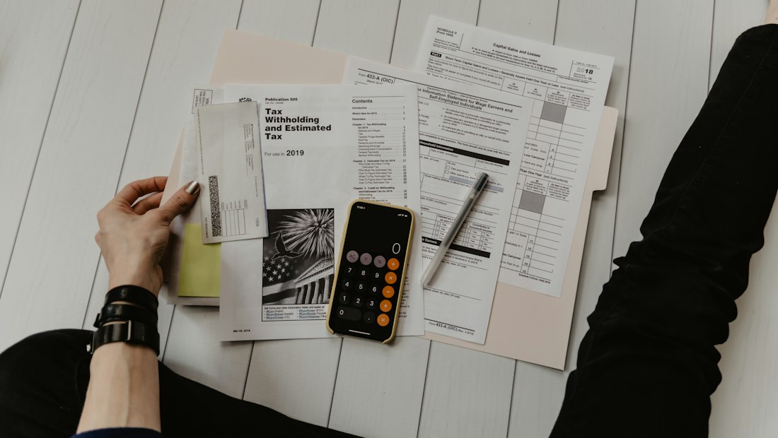 Reviewing financial reports with a calculator
